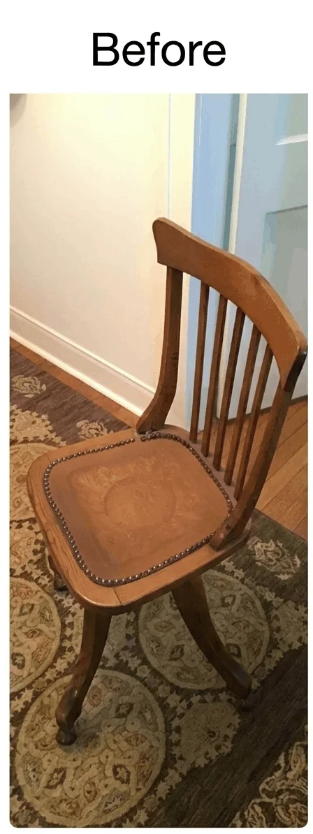 Aging antique parlor chair before restoration with faded wood and its original stamped leather seat.