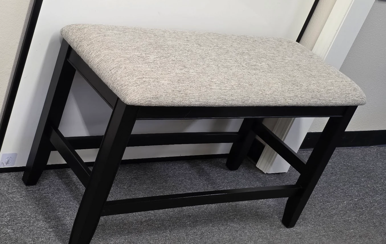 Finished upholstered bench after its snapped structural support was replaced and the frame reinforced.
