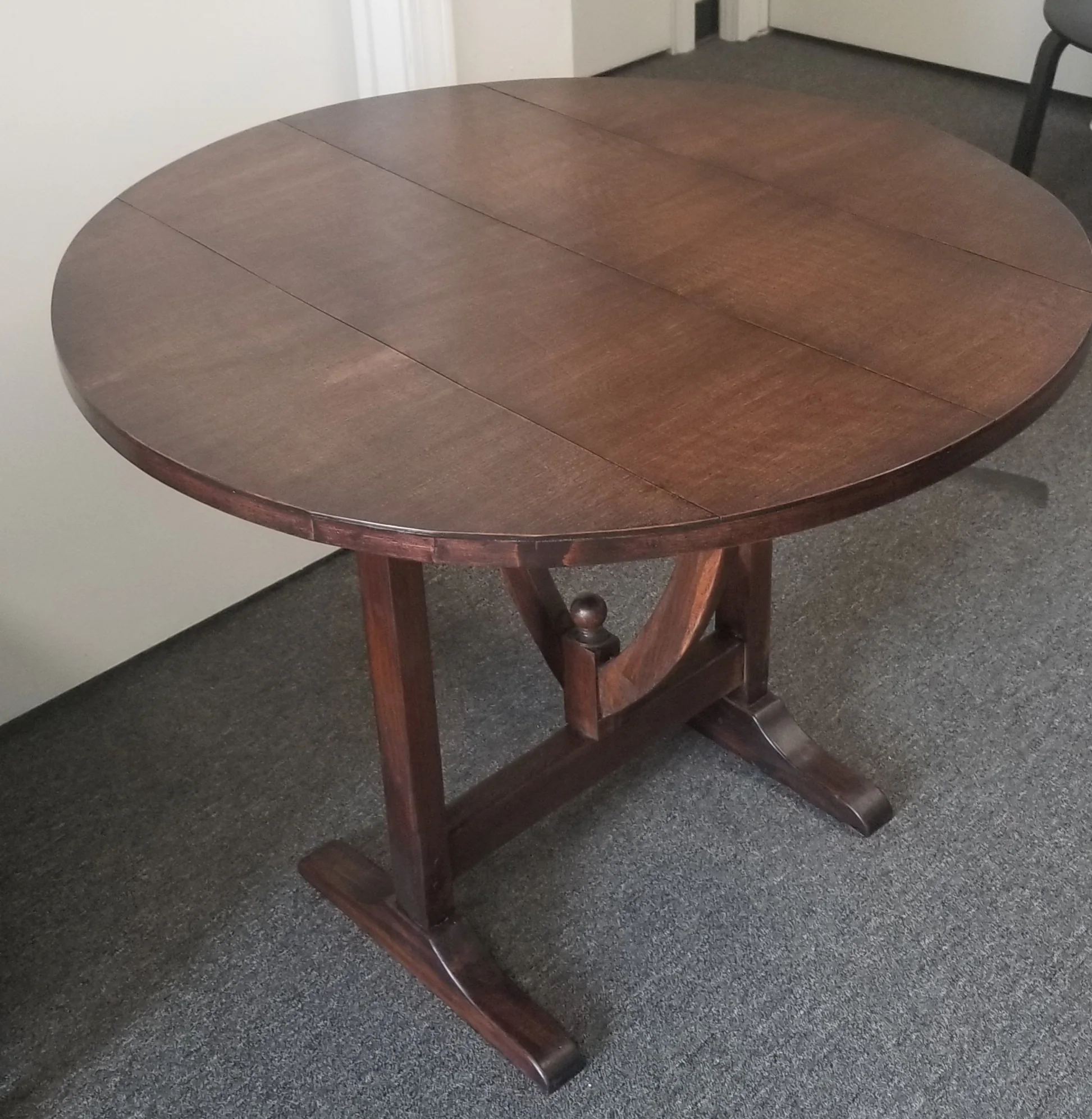 Restored round wooden table rebuilt after severe termite damage so it could remain in the owner's family.