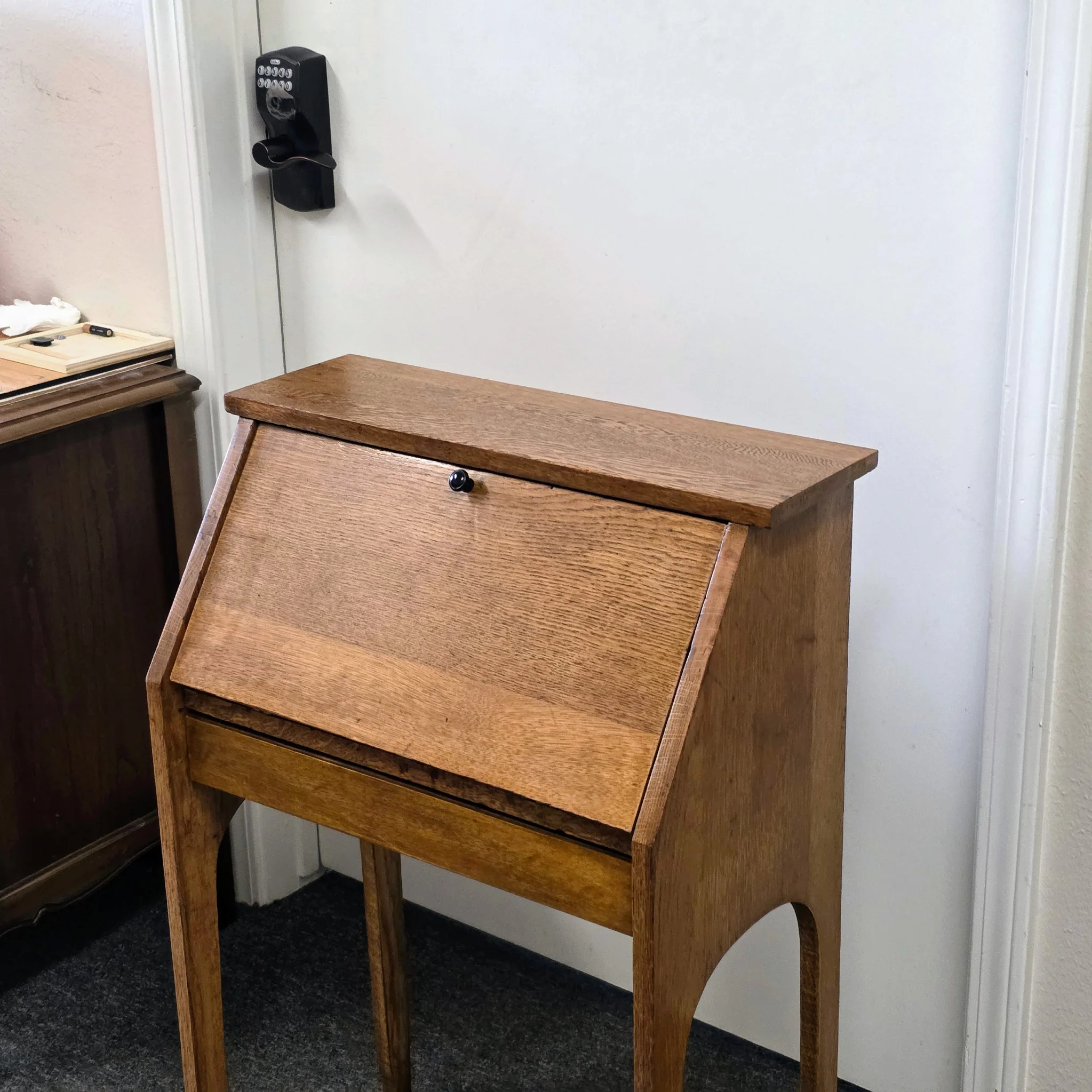 Restored solid-oak secretary desk after scorching, hinge replacement, sanding, and refinishing.