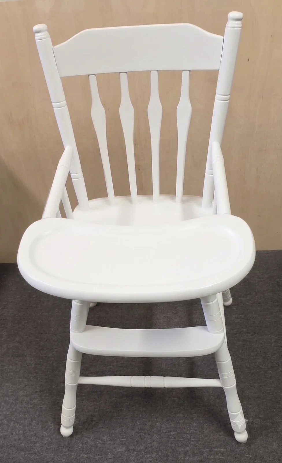 A fully restored and newly painted white wooden baby high chair with a clean tray and sturdy frame.