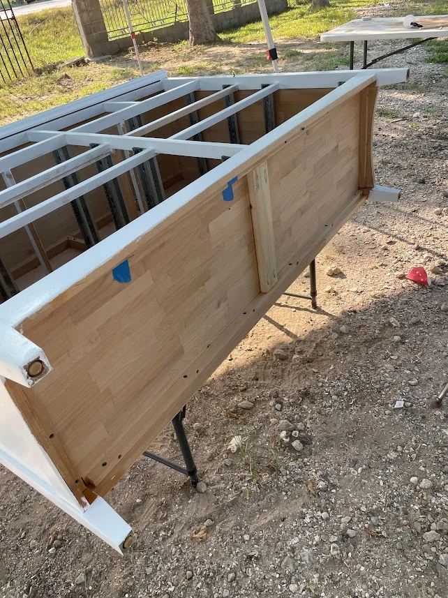 The underside of the dresser frame showing the internal wood structure.